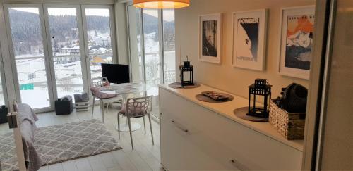 a kitchen with a table and a dining room at Apartament 25 Czarna Góra nr 5 Ischgl in Sienna