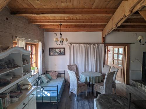 a living room with a blue couch and a table at Pokoje u Agnieszki in Dwernik