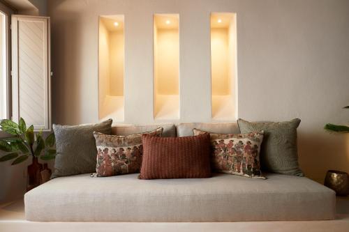 a couch with pillows on it in a living room at Domus Hestia Suites in Pirgos