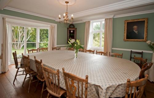 a dining room with a table and chairs at Tros Yr Afon Holiday Cottages and Manor House in Beaumaris