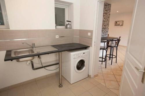a kitchen with a washing machine and a sink at Le Petit Concise à 20mn du Mont Saint Michel in Saint-James