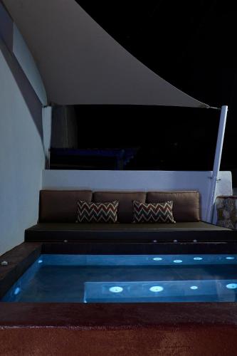 a couch with pillows sitting on top of a building at Domus Hestia Suites in Pirgos