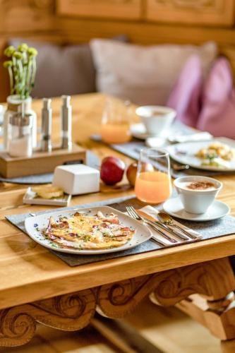 a wooden table with a plate of food on it at GIRLINGGUT Schlafen Starten Salzburg in Elixhausen