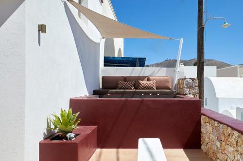 a couch sitting on top of a balcony at Domus Hestia Suites in Pirgos