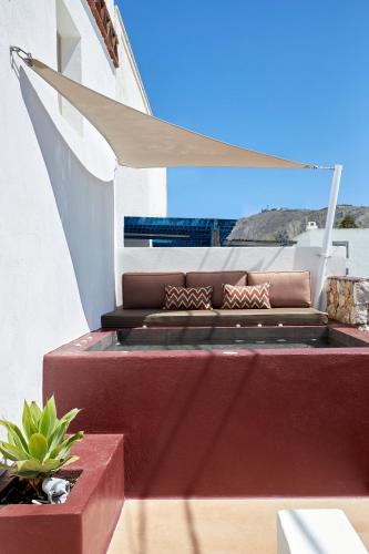 a balcony with a couch on a boat at Domus Hestia Suites in Pirgos