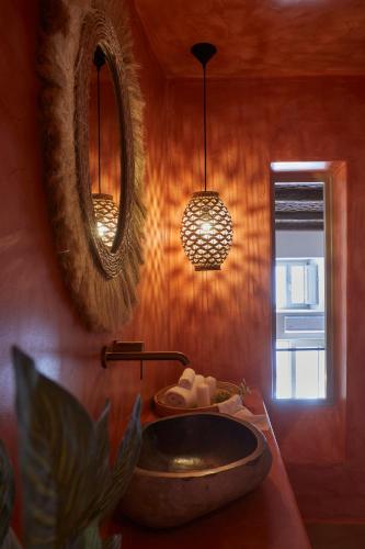 a bathroom with a sink and a mirror at Domus Hestia Suites in Pirgos