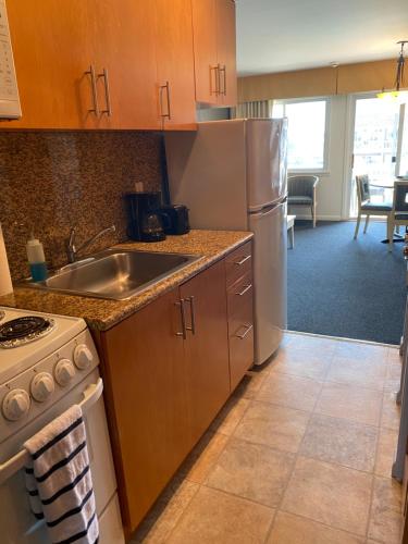 a kitchen with a sink and a refrigerator at Apartment in Royal Atlantic Beach Resort in Montauk