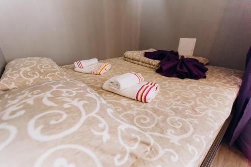 a bed with pillows on it in a bedroom at — Premium apartment — in Ivano-Frankivsʼk