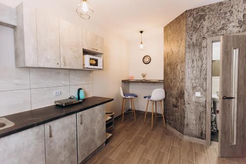 a kitchen with a counter and chairs in a room at — Premium apartment — in Ivano-Frankivsʼk