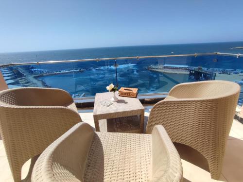 a group of chairs and a table on a balcony at Jewel San Stefano Hotel in Alexandria