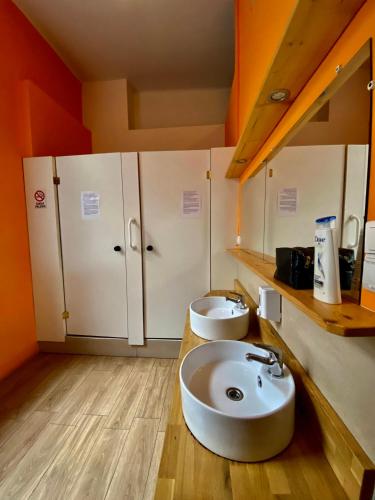 a bathroom with two sinks and cabinets in a room at SKY HOSTEL in Krakow