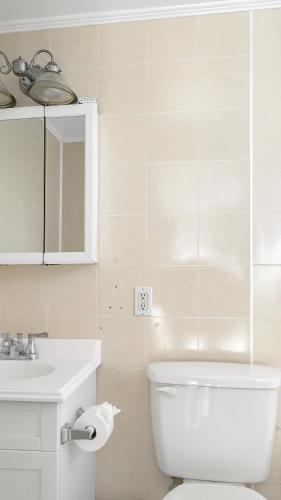 a bathroom with a white toilet and a sink at Driftwood Resort on the Ocean in Montauk