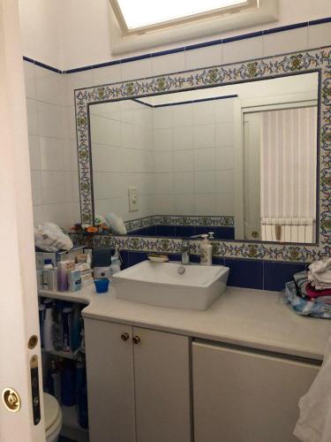 a bathroom with a sink and a mirror at Casa Malù in Torre Annunziata