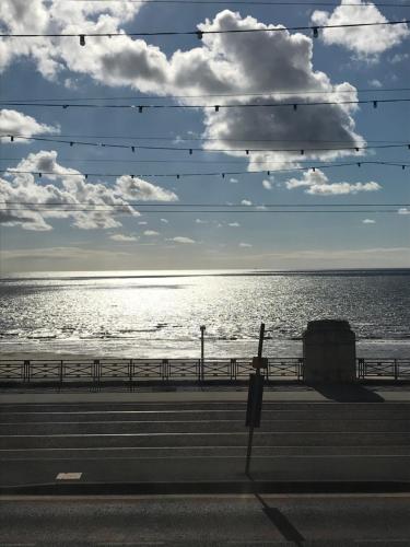 a view of the ocean with birds sitting on wires at The Rutland in Blackpool