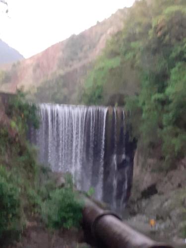 a waterfall on the side of a hill at Mack's Home in Clifton