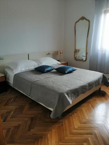 a bedroom with a large bed with a mirror at Olive Garden Accomodation in Savar