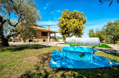 an inflatable pool in the yard of a house at Poggio della Stella in Blera