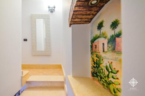 a room with stairs and a painting on the wall at Almanzar - Residenze sul mare in Lampedusa