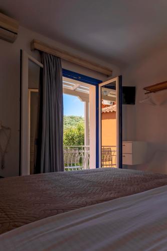 a bedroom with a bed and a window with a view at ASTRA in Parga