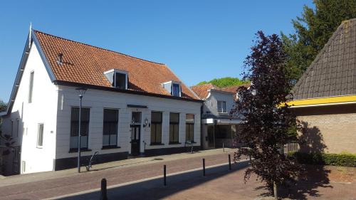 a row of white buildings on a street at BB Salem in Strijen