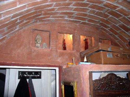 a room with a brick wall and a door at le mirador in Hammamet
