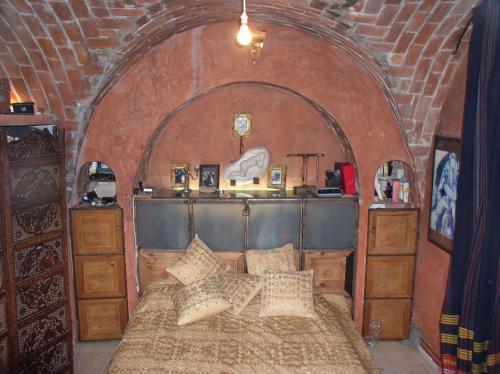 a bedroom with a bed with pillows on it at le mirador in Hammamet
