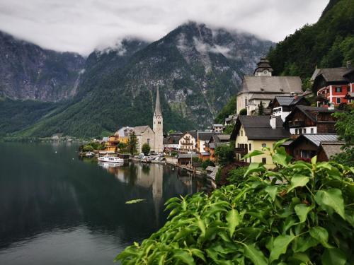 a large body of water surrounded by mountains at Pension Bergfried in Hallstatt