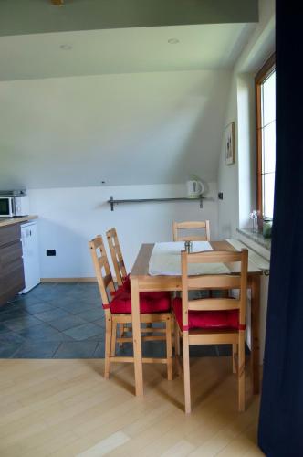 a kitchen with a wooden table and two chairs at Rudi Hiti's Guest House in Bled