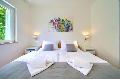 Ένα ή περισσότερα κρεβάτια σε δωμάτιο στο Apartments Adria Danka