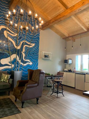 a living room with a large painting on the wall at El Habar de Pria in La Pesa