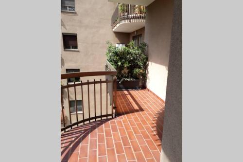 a balcony of a building with a brick walkway at Lario Promenade: family friendly apartment in Como in Como