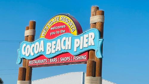 a sign for a beach party on a pole at Casa Flamingo in Cape Canaveral