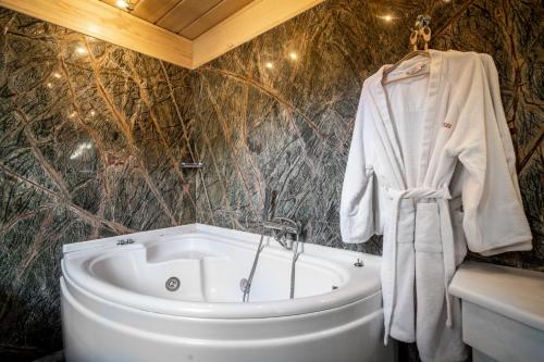 a bathroom with a white bath tub and a sink at Hotel Giamandes in Elati Trikalon