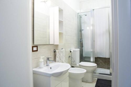 a bathroom with a sink and a toilet and a shower at Casa Mitch in Catania
