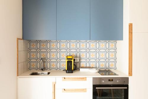 a kitchen with a counter top with a blue at Dimora Labbate in Polignano a Mare