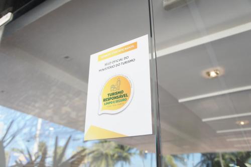 a sign on the door of a building at Nobile Suítes Tambaú in João Pessoa