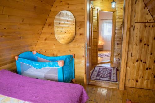 a bedroom with a bed in a wooden room at Village Borje in Žabljak