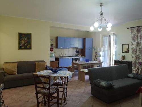 a living room with a couch and a table at Relax House in Giardini Naxos