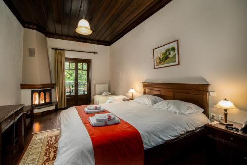 a bedroom with a large bed with two towels on it at Hotel Giamandes in Elati Trikalon