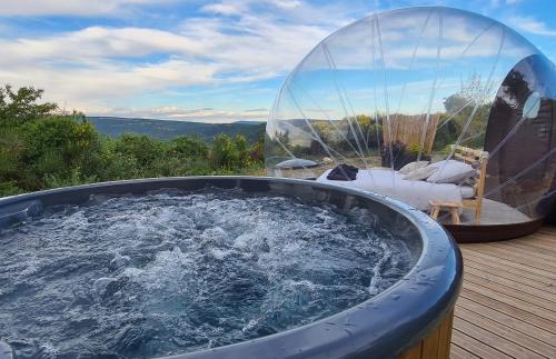 a hot tub with a glass dome on a deck at Hébergements insolites - Détente en Luberon in Viens
