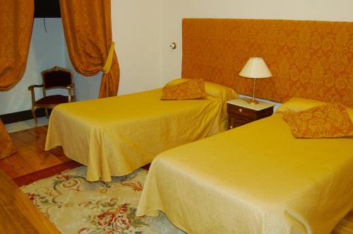 a hotel room with two beds and a lamp at ARTE Y NATURA VALDIVIELSO in Quintana de Valdivielso