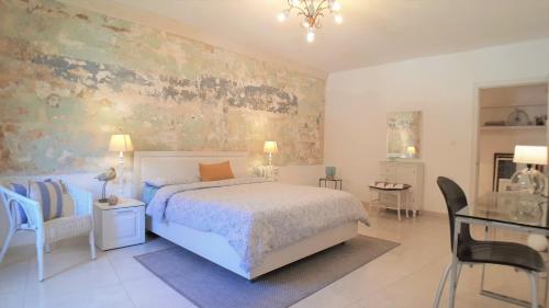 a bedroom with a bed and a table and chairs at Centre Point, Malta's most central in Pieta