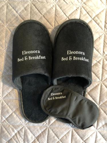 a pair of black socks sitting on a bed at Eleonora Bed & Breakfast in Kristiinankaupunki