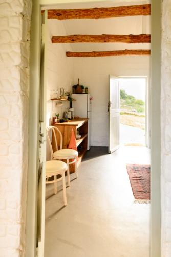 a kitchen with a table and a refrigerator at Laughing Waters Farm in Stanford