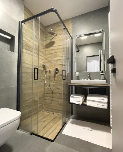 a bathroom with a shower and a sink at Restaurant & Pension u Hradu in Šternberk