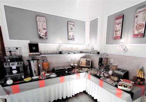 a kitchen with a counter with aasteryasteryasteryasteryasteryasteryasteryasteryastery at Sherwood Hotel Vojkovice nad Ohří in Vojkovice