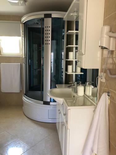 a bathroom with a large shower and a sink at Apartments Ivana Rab in Rab