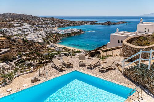 an aerial view of a villa with a pool and the ocean at Villa Thelgo Mykonos in Psarou