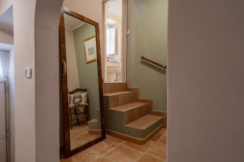 a bathroom with a stairway with a mirror at Agliata 138 in Petralia Sottana