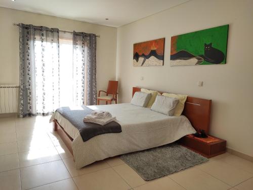 una camera da letto con un letto grande e una finestra di Refúgio da Ria a Vagos